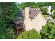Aerial view of home showing the screened in porch and beautiful, tree-filled surroundings at 4876 Sara Creek Way, Sugar Hill, GA 30518