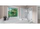 This bright bathroom features a soaking tub and separate glass enclosed shower at 4876 Sara Creek Way, Sugar Hill, GA 30518