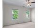 Spacious bedroom with neutral carpet and two large windows bringing in natural light at 4876 Sara Creek Way, Sugar Hill, GA 30518
