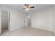 A well lit bedroom with neutral carpet and walls and access to two doorways at 4876 Sara Creek Way, Sugar Hill, GA 30518