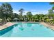 Inviting community pool with a mushroom fountain feature and plenty of lounge chairs at 4876 Sara Creek Way, Sugar Hill, GA 30518