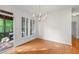 Bright dining room with hardwood floors, white shutters, and a screened-in porch access for indoor/outdoor living at 4876 Sara Creek Way, Sugar Hill, GA 30518