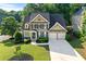 Aerial view of the home showcasing its well-manicured lawn, landscaping, and curb appeal at 4876 Sara Creek Way, Sugar Hill, GA 30518