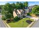 Aerial view of a home with well-maintained landscaping and a spacious front lawn at 4876 Sara Creek Way, Sugar Hill, GA 30518