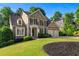 Charming two-story home boasts a landscaped yard, a two-car garage, and classic shutters at 4876 Sara Creek Way, Sugar Hill, GA 30518