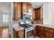 Well-equipped kitchen with stainless steel oven, granite countertops, decorative backsplash, and wooden cabinetry at 4876 Sara Creek Way, Sugar Hill, GA 30518