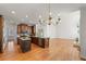Spacious kitchen featuring wooden cabinets, granite countertops, stainless steel appliances, and an open floor plan at 4876 Sara Creek Way, Sugar Hill, GA 30518