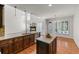 Open concept kitchen with dark wood cabinets, granite countertops, stainless steel appliances, and view of living area at 4876 Sara Creek Way, Sugar Hill, GA 30518