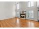 Open-concept living room featuring a fireplace and high ceilings with abundant natural light at 4876 Sara Creek Way, Sugar Hill, GA 30518