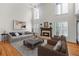 Spacious living room with high ceilings, fireplace, large windows, and comfortable seating at 4876 Sara Creek Way, Sugar Hill, GA 30518