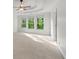 The spacious main bedroom features tray ceilings, a ceiling fan and bright windows for lots of light at 4876 Sara Creek Way, Sugar Hill, GA 30518