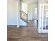 A bright entryway with wood flooring, a staircase, and glass doors to the side at 680 Redhead Way(Lot 22), Grayson, GA 30017