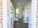 The home's entryway with wood flooring, a staircase, and glass doors ahead at 680 Redhead Way(Lot 22), Grayson, GA 30017