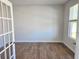 A naturally lit living room featuring hard-wood floors, a white wall, and windows at 680 Redhead Way(Lot 22), Grayson, GA 30017