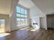 Bright living room featuring hardwood floors, fireplace and large windows overlooking a lake at 680 Redhead Way(Lot 22), Grayson, GA 30017