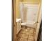 Clean bathroom with a white vanity, updated tile flooring, and a shower-tub combination at 867 Commodore Nw Dr, Atlanta, GA 30318