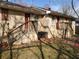 Back of a multi-unit dwelling with separate entrances, wooden stairs, and a small grassy area at 867 Commodore Nw Dr, Atlanta, GA 30318