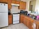 Functional kitchen with tile floors, white appliances, and ample counter space, ready for customization at 867 Commodore Nw Dr, Atlanta, GA 30318