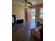 Inviting living room with modern ceiling fan, wood-look flooring, and a view of the front yard at 867 Commodore Nw Dr, Atlanta, GA 30318