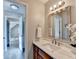 Bathroom features marble countertops, a stylish mirror, and an open doorway to an adjacent room at 1112 Birch Sw St, Atlanta, GA 30310