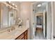 Bathroom features a marble countertop, a stylish mirror, and an open doorway to an adjacent room at 1112 Birch Sw St, Atlanta, GA 30310