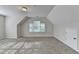 Spacious bonus room with cozy carpet, neutral walls, and lots of natural light at 1112 Birch Sw St, Atlanta, GA 30310