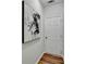 Minimalist hallway with modern painting and wood floors leading to a white door at 1112 Birch Sw St, Atlanta, GA 30310