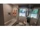 Well-lit bathroom featuring a subway-tiled tub, pedestal sink, and charming décor for a comfortable feel at 2132 Clairmont Rd, Brookhaven, GA 30033