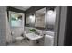 Charming bathroom with a pedestal sink, subway tile, and a large mirror, creating a bright and clean space at 2132 Clairmont Rd, Brookhaven, GA 30033