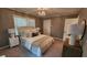 Serene bedroom with a crystal chandelier, neutral decor, large window, and plush bedding, perfect for relaxation at 2132 Clairmont Rd, Brookhaven, GA 30033