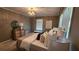 Sunlit bedroom featuring a crystal chandelier, neutral decor, and comfortable furnishings with natural light at 2132 Clairmont Rd, Brookhaven, GA 30033