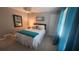 Cozy bedroom featuring neutral walls, a bed with blue accents, and natural light from a window at 2132 Clairmont Rd, Brookhaven, GA 30033
