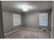 This bedroom has gray walls, carpeted floors, and windows with blinds allowing ample natural light at 2132 Clairmont Rd, Brookhaven, GA 30033