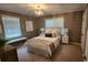 Comfortable bedroom with a crystal chandelier, large windows, neutral tones, and stylish furnishings at 2132 Clairmont Rd, Brookhaven, GA 30033