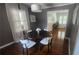 Cozy dining area featuring a round wooden table, white chairs, white curtains and hardwood floors at 2132 Clairmont Rd, Brookhaven, GA 30033