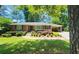 Charming one-story brick home with mature landscaping, a well-manicured lawn, and a convenient carport at 2132 Clairmont Rd, Brookhaven, GA 30033