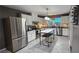 Open kitchen with stainless steel appliances, white cabinets, center island, and great natural light at 2132 Clairmont Rd, Brookhaven, GA 30033