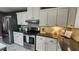 Kitchen with stainless steel appliances, white cabinets, dark countertops, and open layout at 2132 Clairmont Rd, Brookhaven, GA 30033