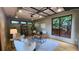 A well-lit home office with a glass ceiling, complemented by a modern desk and a comfortable seating area at 2132 Clairmont Rd, Brookhaven, GA 30033