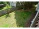 The backyard is spacious, grassy and fenced with some mature trees at 30 W Fork Way, Temple, GA 30179