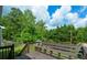 The backyard deck overlooks a lush green lawn and mature trees on a beautiful day at 30 W Fork Way, Temple, GA 30179