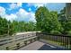 A view from the wood deck overlooking a wooded yard and local thoroughfare at 30 W Fork Way, Temple, GA 30179
