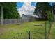 This backyard features an aged fence and mature trees at 30 W Fork Way, Temple, GA 30179