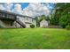 Spacious backyard with lush lawn, mature trees, and a deck, perfect for outdoor living and entertaining at 30 W Fork Way, Temple, GA 30179
