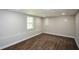 View of the finished basement showcasing the new wood flooring and neutral colored walls at 30 W Fork Way, Temple, GA 30179