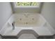 Bathroom showcasing a soaking tub with a large window above at 30 W Fork Way, Temple, GA 30179