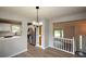 Open dining area showcasing lighting fixture, wood-look floors, and view into the kitchen at 30 W Fork Way, Temple, GA 30179