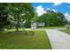 View of a well maintained home on a large lot with a long driveway leading to the attached garage at 30 W Fork Way, Temple, GA 30179