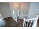 View of the foyer featuring hardwood floors, white railing and a large front door to the left at 30 W Fork Way, Temple, GA 30179