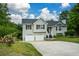 Inviting two-story house with attached garage and lovely landscaping, complemented by a clear blue sky at 30 W Fork Way, Temple, GA 30179